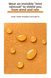 Macro shot of yellow lychee leather with waterproof coating showing water beads