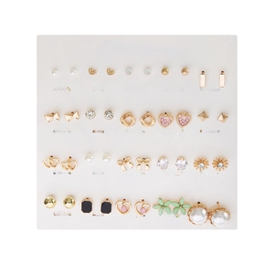 Assorted 20-pair gold earring set with pearls, rhinestones, and hearts on white display card