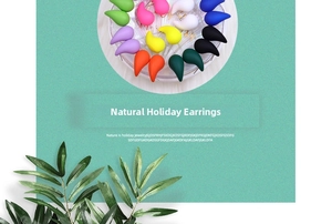 Close-up of matte teardrop earrings in various colors on a mint textured background