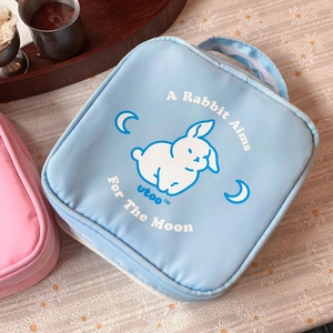 Detail of blue square makeup bag with moon rabbit print and convenient carrying handle