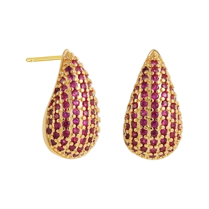 Detailed macro view of teardrop stud earrings with pavé-set red gemstones in gold finish
