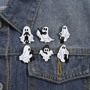 Set of 6 Halloween white ghost and black cat enamel pins on a blue denim jacket pocket