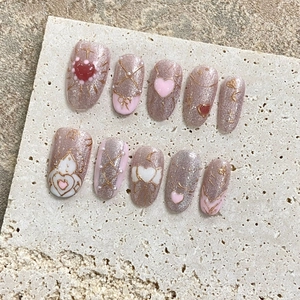 Pink cat eye handmade press-on nails with heart patterns and pearls set on stone