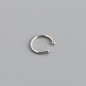 Macro detail of silver S925 sterling silver ear cuff with minimalist U-shape and smooth beads