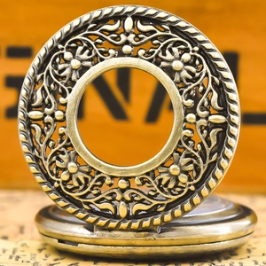 Detailed view of an antique bronze pocket watch with an intricate hollow floral pattern