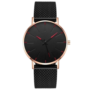 Close-up of black mesh watch strap with rose gold case and red hour markers on dial