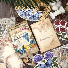 Flat lay of vintage scrapbooking kit featuring butterfly stickers and floral craft paper