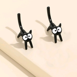Cute black cat stud earrings in minimalist cartoon style with glossy metal finish