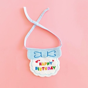Detailed embroidery of Happy Birthday text on light blue pet bib with white lace trim