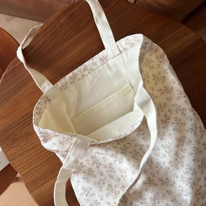 Macro shot of large cotton tote bag interior pocket and brown vintage floral print