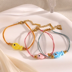 Handmade woven cord bracelet with ceramic fish pendant in 18K gold plated stainless steel