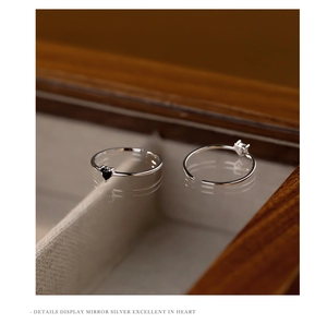 Close-up of S925 silver adjustable rings with black and white heart-shaped zircon stones
