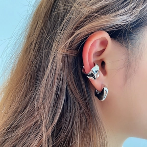 Macro shot of liquid metal S925 silver irregular ear cuff with textured surface