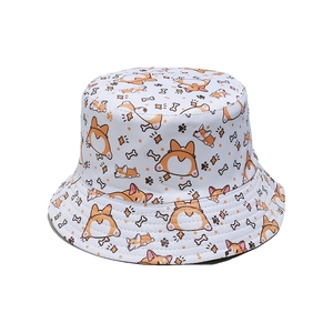 Detail of white bucket hat featuring all-over cartoon corgi dog prints and neat stitching