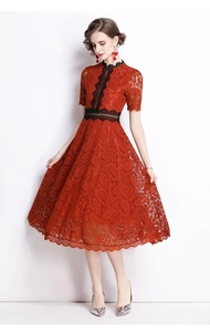 Detail showing red lace midi dress with black embroidery on neckline and waist