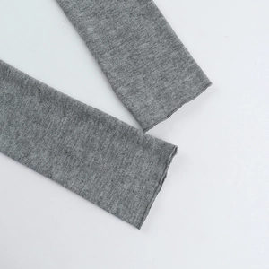 Close-up detail of grey knitted sleeve cuff showing the high-quality fabric texture