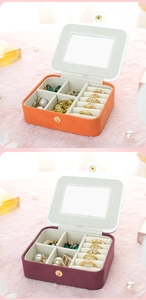 Macro view of portable velvet jewelry box with mirror and multi-compartment ring slots