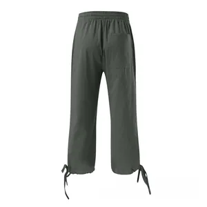 Rear view of dark grey cotton linen pants featuring elastic waist, back pocket and tie cuffs