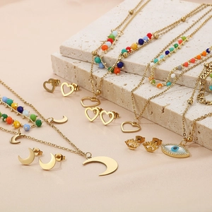 Detailed set of gold Bohemian heart, moon, and evil eye necklaces on stone display