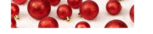 Macro detail of red glitter and matte Christmas ornaments on white fluffy background