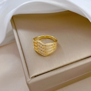 Detailed macro view of gold-plated four-layer ring with sparkling pave zircon settings
