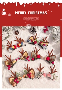 Detailed set of Christmas reindeer antler hair clips with festive pine cones and berries