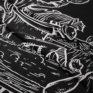 Close-up of white bohemian illustration on black fabric with fine fiber texture