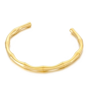 Minimalist gold stainless steel open bangle with unique bamboo joint design on white background