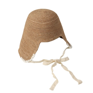 Handmade raffia straw sun hat with white lace trim and ribbons in a pastoral style