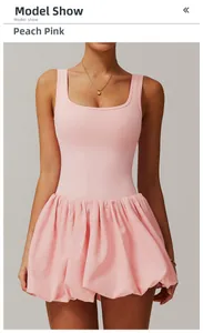 Detailed view of the peach pink athletic dress with pleated skirt and slim fit design