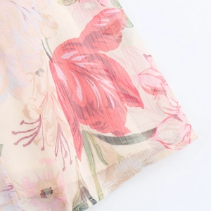 Detailed macro view of elegant floral print chiffon fabric with vibrant rose patterns