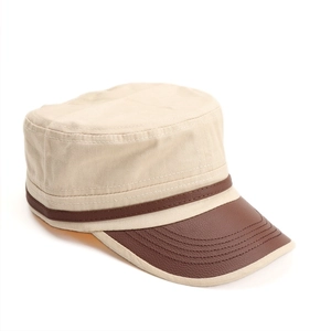 Detail of khaki canvas cadet hat with brown leather brim and fine stitching accents