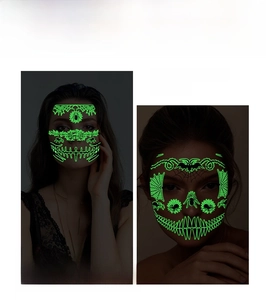 Glow in the dark Halloween face tattoos featuring neon green spider webs and bat designs