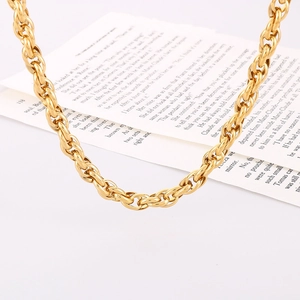 Close-up of a double-layered golden square pendant necklace on an open book