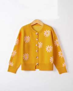 Detail of yellow knit cardigan featuring delicate embroidered daisy flowers and round buttons