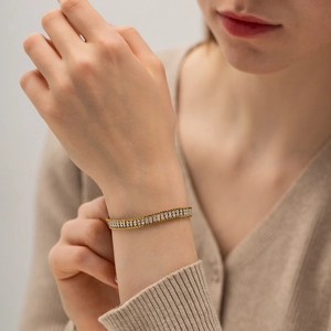 Elegant 18K gold-plated double-row zircon bracelet with braided texture on a model's wrist