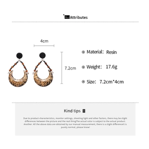 Detail view of crescent resin earrings with gold foil and 7.2cm length dimensions