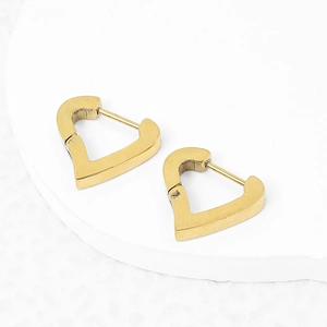 Minimalist golden heart shaped stainless steel hoop earrings on a white stone base