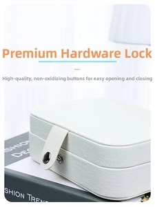Close-up of the white PU leather jewelry box featuring a circular metal snap buckle