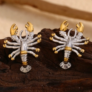 Detailed view of creative lobster-shaped earrings in two-tone gold and silver finish