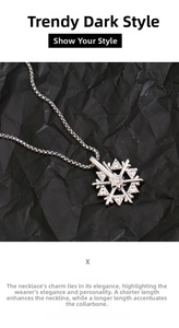 Macro view of rotating silver snowflake pendant with sparkling zircons on a steel chain