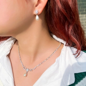 Elegant silver necklace and earrings set with water drop pearls and sparkling zircons