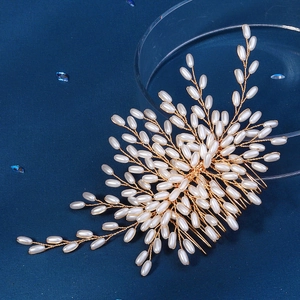 Gold bridal hair comb with white pearls in a leaf pattern for wedding hairstyles