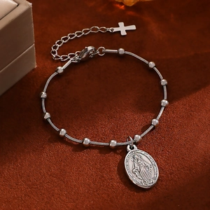 Detail of silver stainless steel bead bracelet with Virgin Mary medal and cross pendant