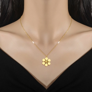 Minimalist titanium steel flower pendant necklace in gold finish on a model