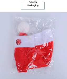 Detailed view of red plush Santa hat with snowflake sequins in clear plastic packaging