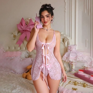 Detailed view of pink lace babydoll with deep V-neck and decorative silk bows