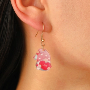 Close-up of pink acrylic gnome earring with Love heart charm worn by a model