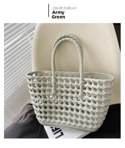 Close-up of army green hollow woven basket bag with round handles for summer vacation