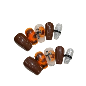 Autumn amber marble press-on nails with metal cross accents and trapezoid shape